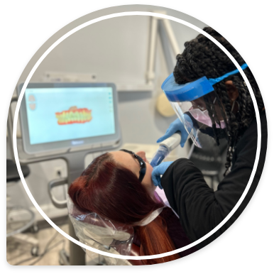 Dental team member taking digital dental impressions of a patient