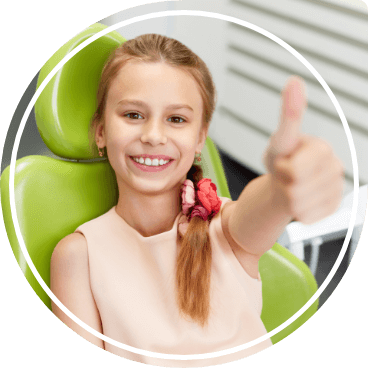 Young girl giving thumbs up in dental chair