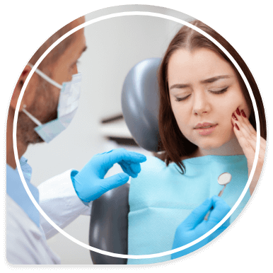 Young woman in dental chair holding her cheek in pain