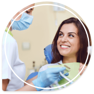 Smiling woman talking to dental team member