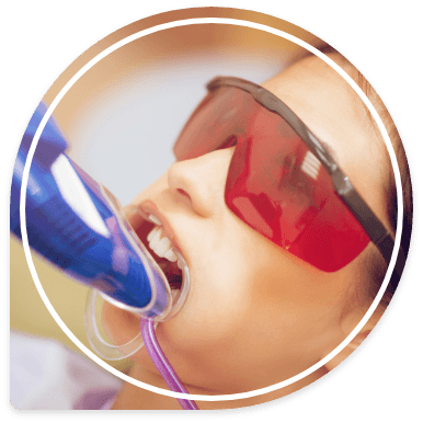 Young woman receiving fluoride treatment in dental office