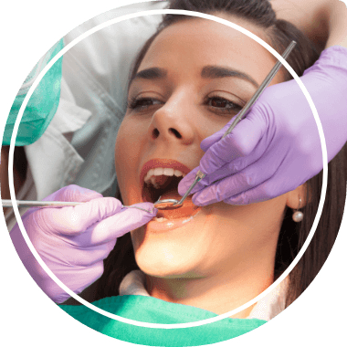 Woman having her mouth examined by dentist