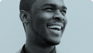 Man laughing and looking off to the side